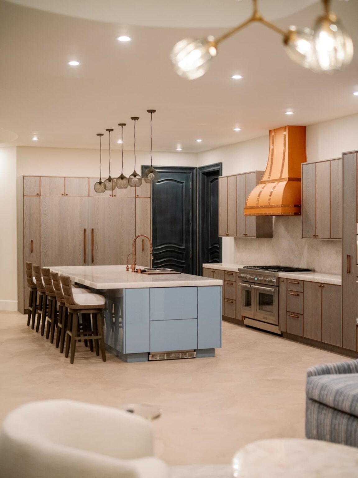 Custom kitchen with a copper hood and a large island in Beverly Hills by Home Deco