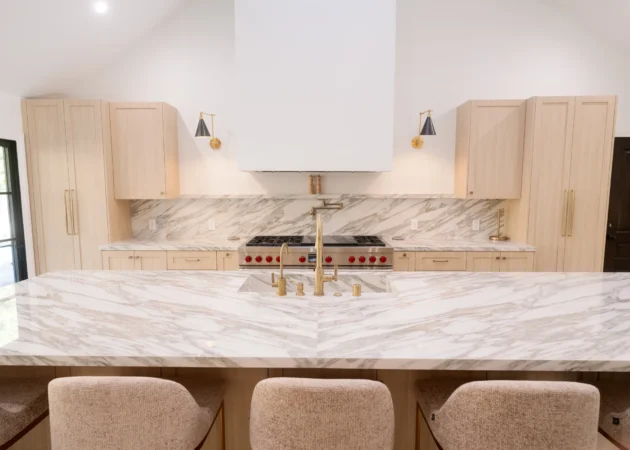 Kitchen with shaker cabinetry, stone island and range wall, Bel Air Project by Home Deco