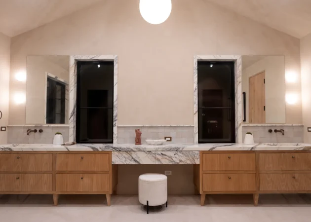 Double vanity bathroom with wood cabinetry, Dickens Project by Home Deco