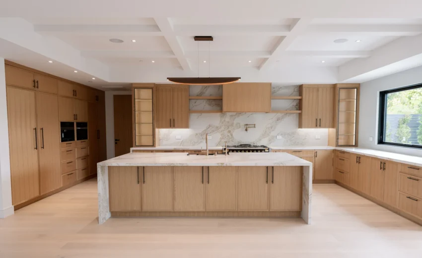 Kitchen with waterfall island and wood cabinetry, Lynngrove Project by Home Deco