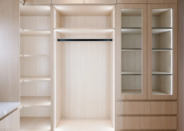 Closet wall with hanging space and glass-front cabinet, Lynngrove Project by Home Deco