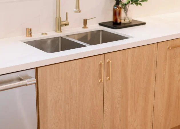 Sink run with brass faucet and slab-door cabinets, Sancola Project by Home Deco
